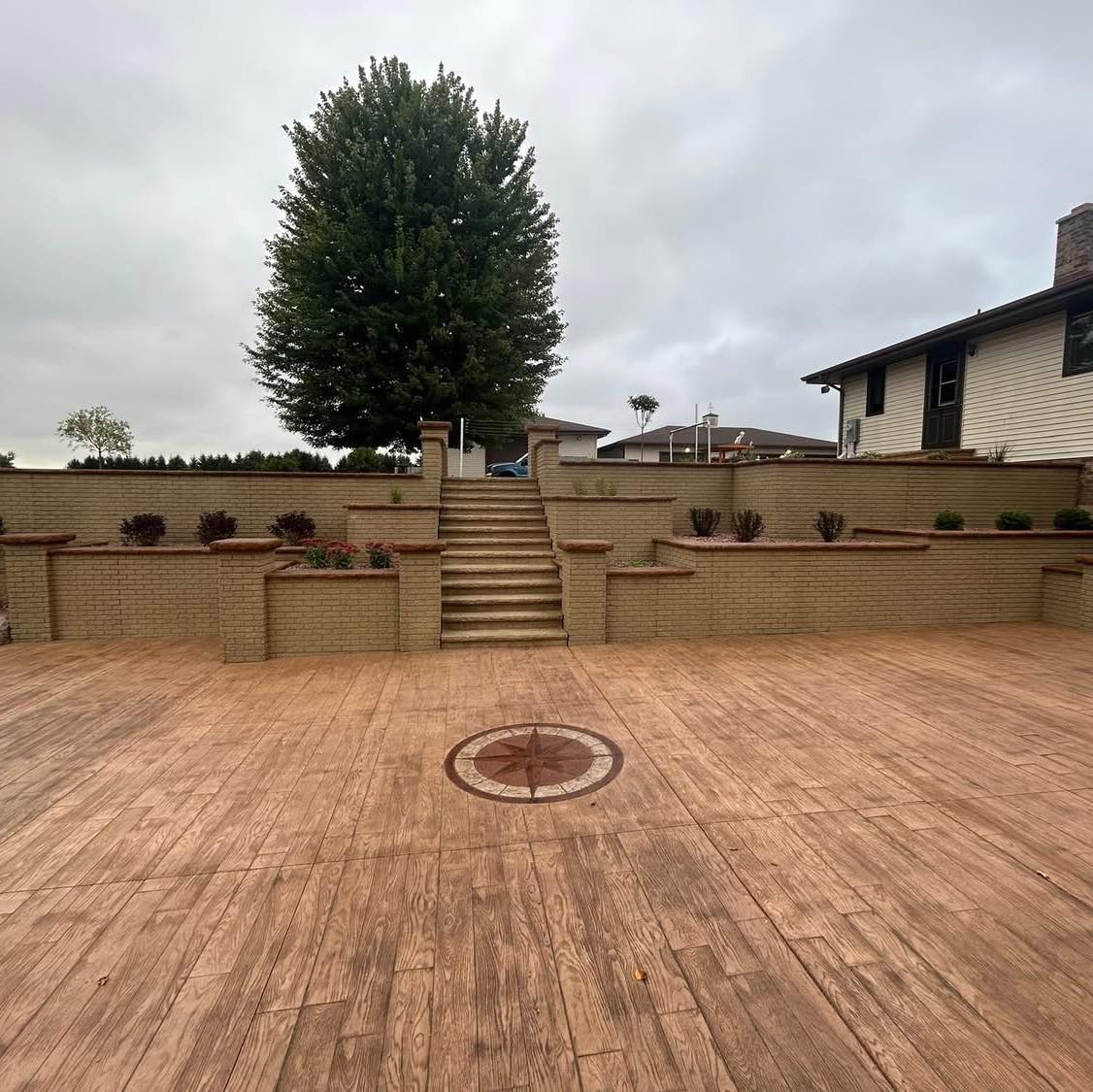Decorative stamped patio with a compass medallion centerpiece - Koeppel Concrete